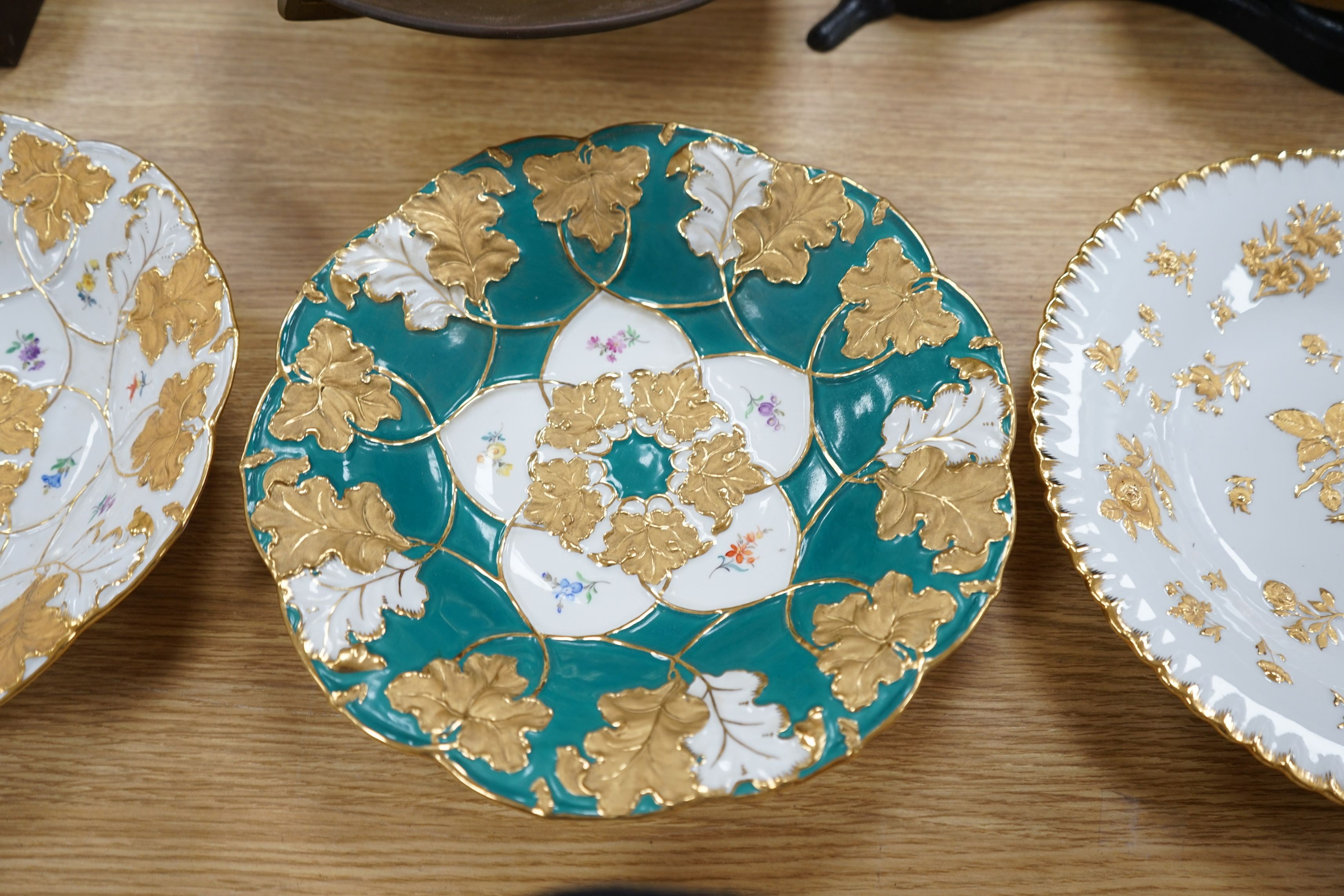 Two Meissen floral and gilt dishes and another shallower dish, 28cms diameter (3)